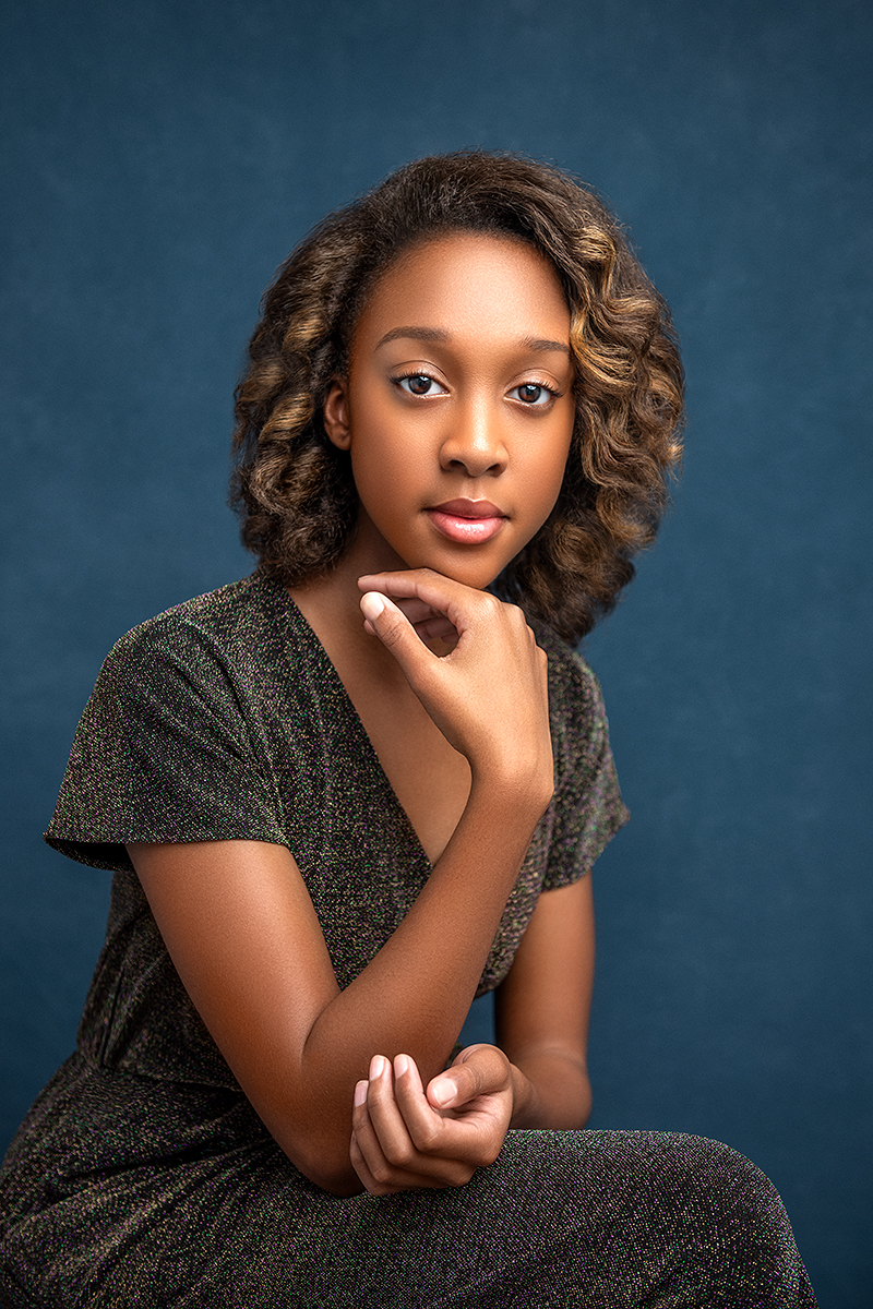 A fine art portrait of a gorgeous African American teen girl, highlighting her beautiful hands, captured by Houston child photographer Tatyana Sokolova