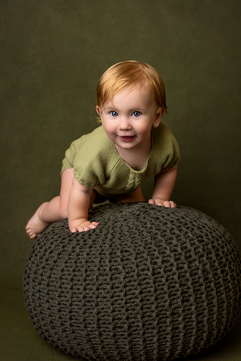 A fine art studio portrait featuring a happy one year old baby girl captured by a Houston Fine Art Child Photographer, Tatyana Sokolova